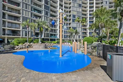 a playground in front of a large apartment building at 1107 Edgewater T3 Beach Resort in Panama City Beach