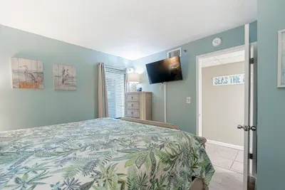 a bedroom with a bed and a flat screen tv at 1107 Edgewater T3 Beach Resort in Panama City Beach