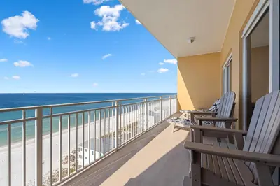 a balcony with chairs and a view of the ocean at 1105 Sterling Beach in Panama City Beach