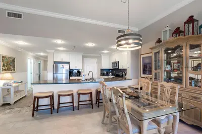 a kitchen with a table and chairs and a counter at 1105 Sterling Beach in Panama City Beach