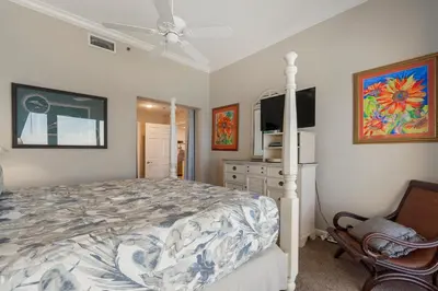 a bedroom with a bed and a television in it at 1105 Sterling Beach in Panama City Beach