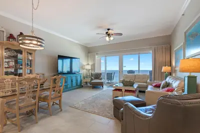 a living room and dining room with a view of the ocean at 1105 Sterling Beach in Panama City Beach