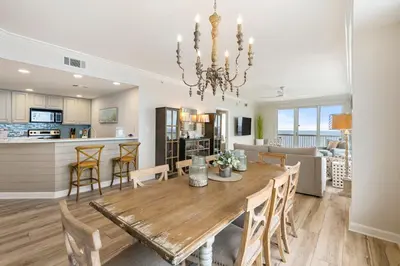 a dining room and kitchen with a table and chairs at 1209 Seychelles in Panama City Beach