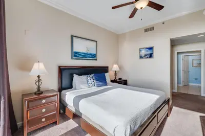 a bedroom with a bed and a ceiling fan at 305 Sterling Beach in Panama City Beach