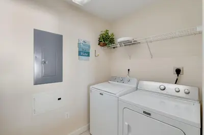 a white laundry room with a washer and dryer at 305 Sterling Beach in Panama City Beach