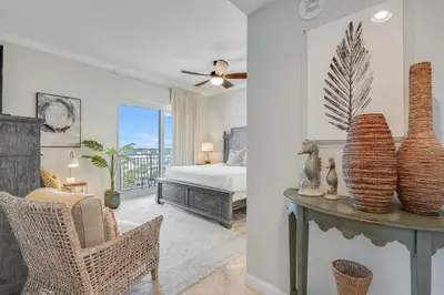 a bedroom with a bed and a table with vases on it at 607 Sterling Beach in Panama City Beach
