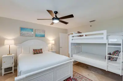 a bedroom with two bunk beds and a ceiling fan at 607 Sterling Beach in Panama City Beach