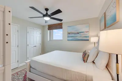a bedroom with a bed and a ceiling fan at 607 Sterling Beach in Panama City Beach