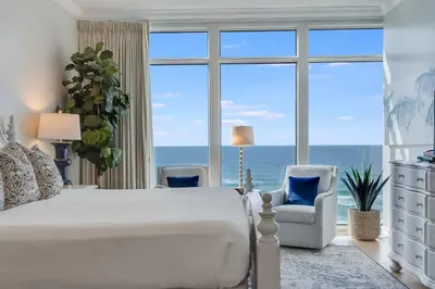 a bedroom with a bed and a large window at 607 Sterling Beach in Panama City Beach