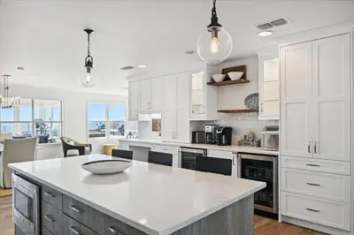 a kitchen with white cabinets and a white counter top at The Southern Yankee in Panama City Beach