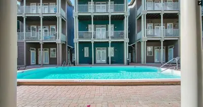 a large swimming pool in front of a building at Sunset Serenity in Panama City Beach