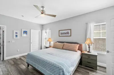 a bedroom with a bed and a ceiling fan at Hilltop Manor in Panama City Beach
