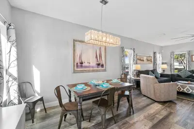 a living room with a table and a couch at Hilltop Manor in Panama City Beach