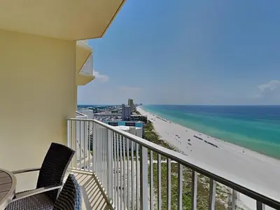 a balcony with chairs and a view of the beach at Boardwalk #1602 in Panama City Beach