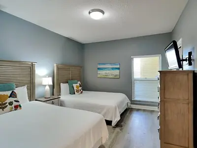 a bedroom with two beds and a window at Boardwalk #1602 in Panama City Beach