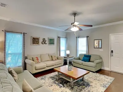 a living room with two couches and a table at Southern Charm in Inlet Beach