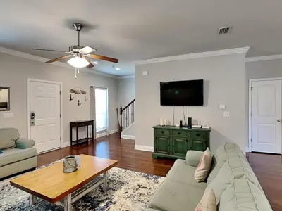 a living room with a couch and a tv at Southern Charm in Inlet Beach