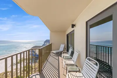 a balcony with chairs and a view of the ocean at Commodore 0607 in Panama City Beach
