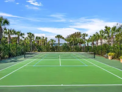 a tennis court with palm trees in the background at Celadon #0606 in Panama City Beach