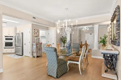 a dining room and kitchen with a table and chairs at Hidden Dunes #201 in Panama City Beach