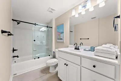 a white bathroom with a sink and a toilet at Hidden Dunes #201 in Panama City Beach