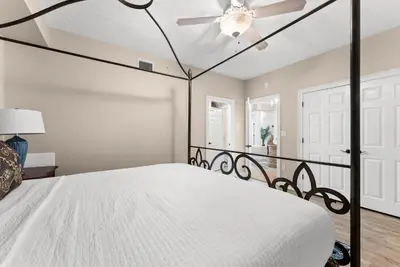 a bedroom with a bed with a ceiling fan at Hidden Dunes #201 in Panama City Beach