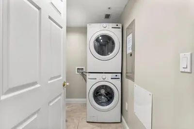 a laundry room with a washer and dryer at Treasure Island #2303 in Panama City Beach