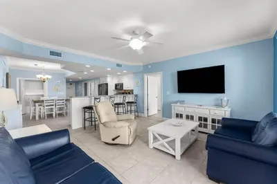 a living room with a couch and a tv at Treasure Island #0106 in Panama City Beach