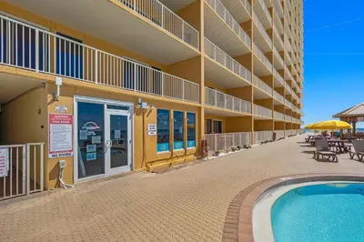a building with a swimming pool in front of a building at Treasure Island #0103 in Panama City Beach