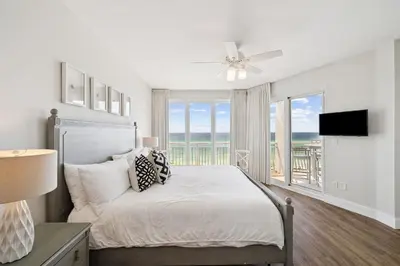 a bedroom with a bed with a view of the ocean at HP 34W On the Shore by 30A Escapes in Rosemary Beach