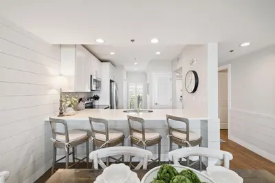 a kitchen and dining room with a table and chairs at HP 34W On the Shore by 30A Escapes in Rosemary Beach