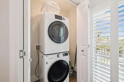 a washer and dryer in a room with a window at HP 34W On the Shore by 30A Escapes in Rosemary Beach