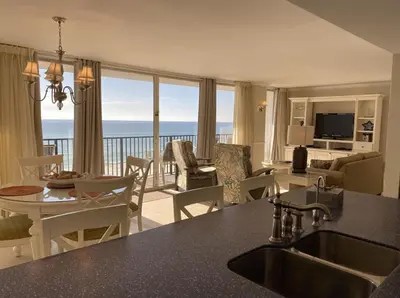 a kitchen and living room with a view of the ocean at Seachase E301 by Emerald Coast Retreats in Panama City Beach