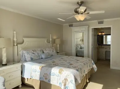 a bedroom with a bed and a ceiling fan at Seachase E301 by Emerald Coast Retreats in Panama City Beach