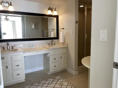 a bathroom with two sinks and a large mirror at Seachase E301 by Emerald Coast Retreats in Panama City Beach