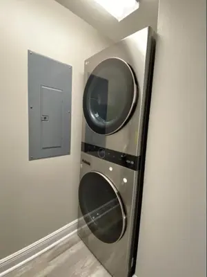a stainless steel washer and dryer in a wall at Celadon 405 by Emerald Coast Retreats in Panama City Beach