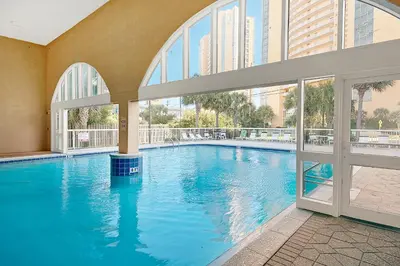 a large swimming pool in a building with windows at Celadon 2005 by Emerald Coast Retreats in Panama City Beach