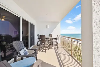 a balcony with chairs and a table and the ocean at HP 35W Gulf Front Condo by 30A Escapes in Rosemary Beach