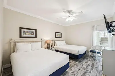 a bedroom with two beds and a ceiling fan at HP 35W Gulf Front Condo by 30A Escapes in Rosemary Beach