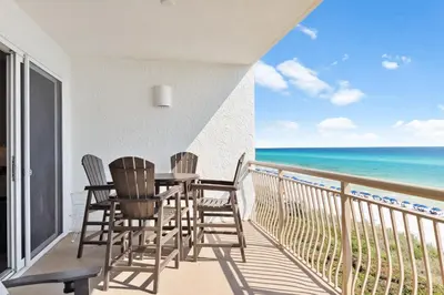 a balcony with a table and chairs and the ocean at HP 35W Gulf Front Condo by 30A Escapes in Rosemary Beach