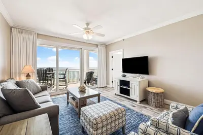 a living room with a couch and a tv at HP 35W Gulf Front Condo by 30A Escapes in Rosemary Beach