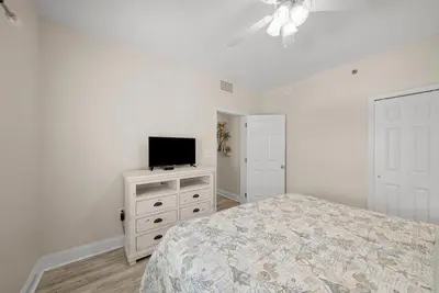 a bedroom with a bed and a television on a dresser at Laketown Wharf #1826 in Panama City Beach