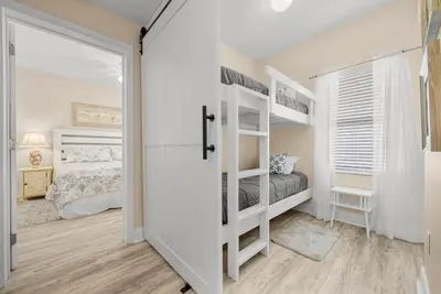 a bedroom with two bunk beds and a door at Laketown Wharf #1826 in Panama City Beach