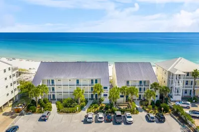 an aerial view of a hotel with cars parked in a parking lot at 30A Eastern Shores Condominiums by Panhandle Getaways in Santa Rosa Beach