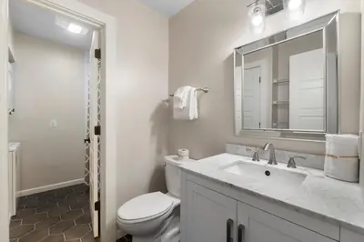 a bathroom with a toilet and a sink and a mirror at 30A Eastern Shores Condominiums by Panhandle Getaways in Santa Rosa Beach