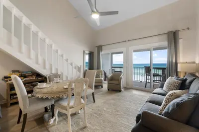 a living room with a table and a couch at 30A Eastern Shores Condominiums by Panhandle Getaways in Santa Rosa Beach