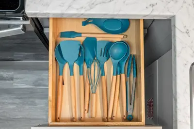 a bunch of utensils in a wooden drawer at Bombastic Beach Bungalow, 10 Min WALK to the Beach in Panama City Beach