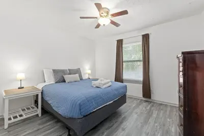 a bedroom with a bed and a ceiling fan at Bombastic Beach Bungalow, 10 Min WALK to the Beach in Panama City Beach