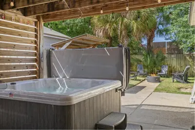 a hot tub in a backyard with a patio at Bombastic Beach Home, HOT TUB, 8min WALK to Beach in Panama City Beach