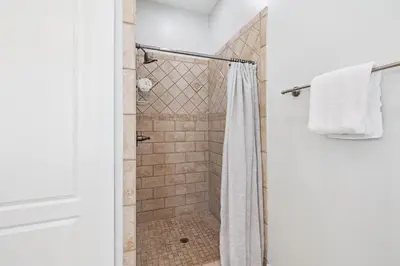 a bathroom with a shower with a shower curtain at Saltwater Therapy on 30A by 30A Escapes in Seacrest